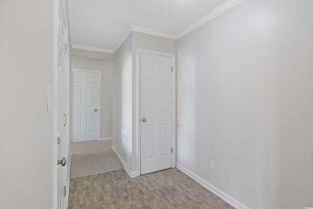 hall with crown molding, wood finished floors, and baseboards
