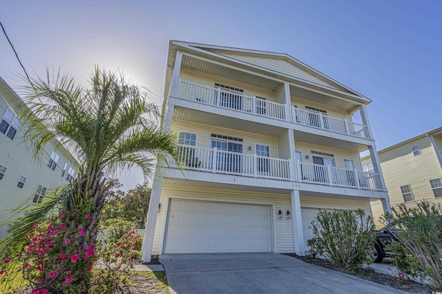 703 37th Ave S, North Myrtle Beach, SC 29582 - coastal home with a balcony, a garage, and concrete driveway