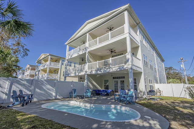 703 37th Ave S, North Myrtle Beach, SC 29582 - rear view of property with ceiling fan, french doors, a fenced backyard, outdoor lounge area, and a patio