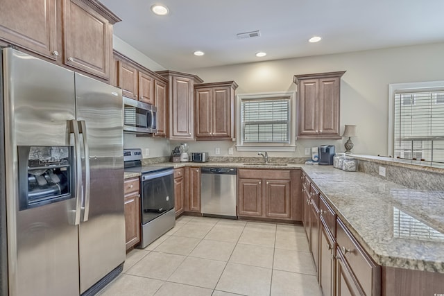 703 37th Ave S, North Myrtle Beach, SC 29582 - kitchen featuring appliances with stainless steel finishes, a sink, a peninsula, plenty of natural light, and recessed lighting