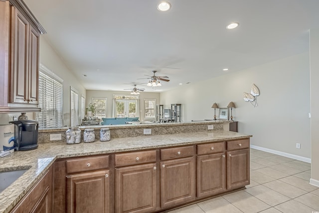 703 37th Ave S, North Myrtle Beach, SC 29582 - kitchen featuring a peninsula, a ceiling fan, light tile patterned flooring, recessed lighting, and light stone counters