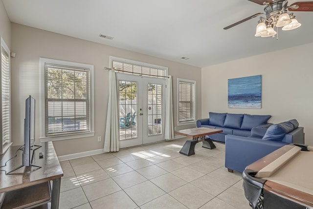 703 37th Ave S, North Myrtle Beach, SC 29582 - living room with french doors, light tile patterned floors, a ceiling fan, and baseboards