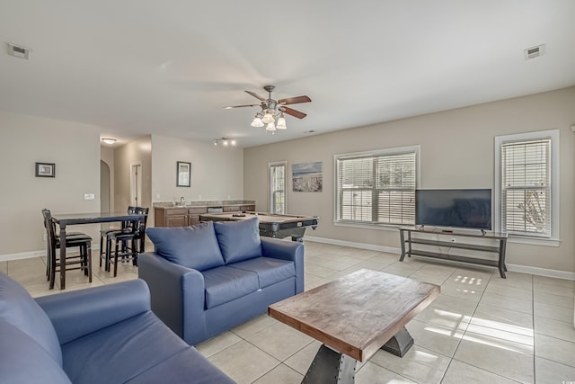 703 37th Ave S, North Myrtle Beach, SC 29582 - living area featuring light tile patterned floors, ceiling fan, baseboards, and arched walkways