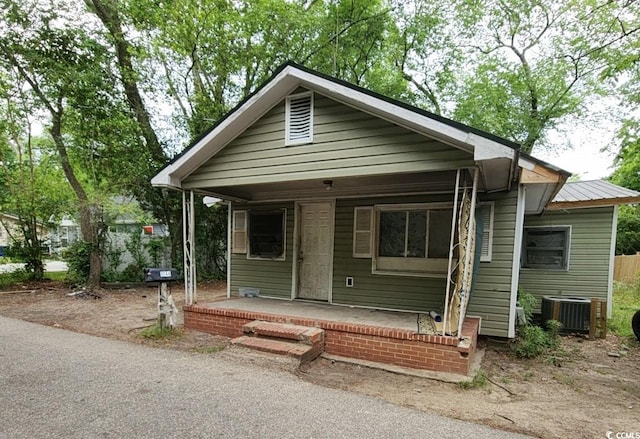 bungalow-style home with central AC and a porch