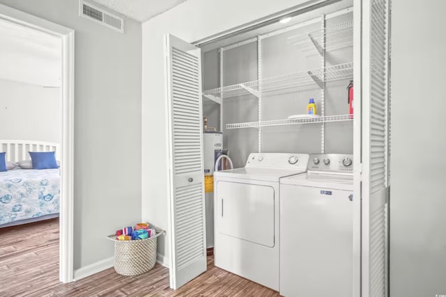 612 N Ocean Blvd Unit 103, Surfside Beach, SC 29575 - laundry area with separate washer and dryer, wood finished floors, baseboards, and water heater