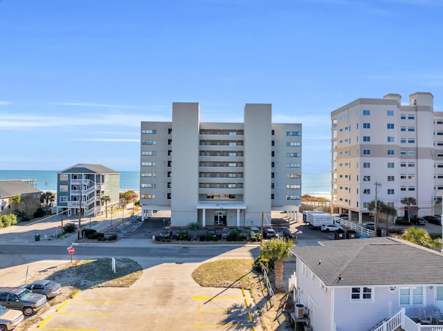 5806 N Ocean Blvd Unit 203, North Myrtle Beach, SC 29582 - view of building exterior featuring a water view, uncovered parking, and cooling unit