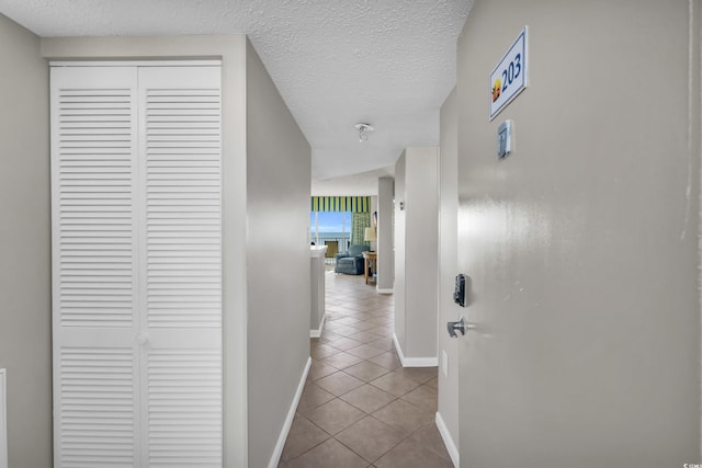 5806 N Ocean Blvd Unit 203, North Myrtle Beach, SC 29582 - hall featuring tile patterned floors, baseboards, and a textured ceiling