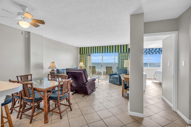 5806 N Ocean Blvd Unit 203, North Myrtle Beach, SC 29582 - dining room featuring a ceiling fan, plenty of natural light, a textured ceiling, and light tile patterned floors