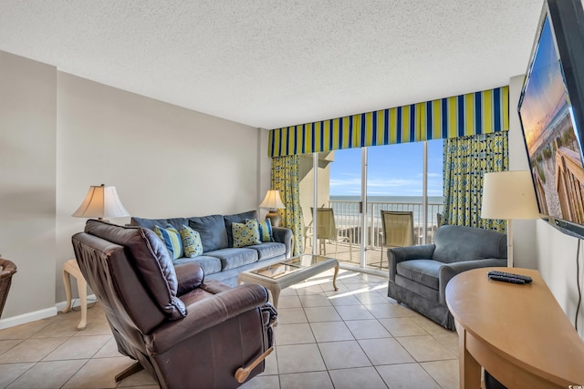 5806 N Ocean Blvd Unit 203, North Myrtle Beach, SC 29582 - living area featuring tile patterned floors, a textured ceiling, and baseboards