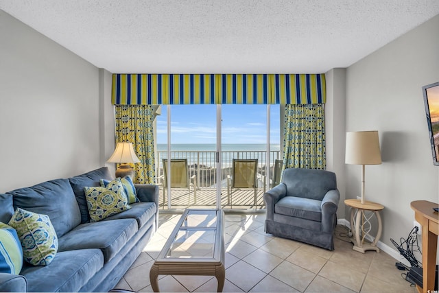 5806 N Ocean Blvd Unit 203, North Myrtle Beach, SC 29582 - living area featuring wallpapered walls, a textured ceiling, baseboards, and tile patterned floors