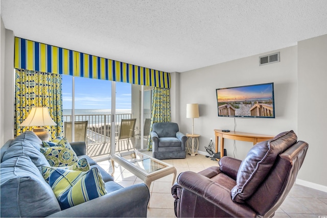 5806 N Ocean Blvd Unit 203, North Myrtle Beach, SC 29582 - tiled living area with baseboards and a textured ceiling