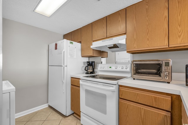 5806 N Ocean Blvd Unit 203, North Myrtle Beach, SC 29582 - kitchen with white appliances, under cabinet range hood, light countertops, light tile patterned floors, and baseboards