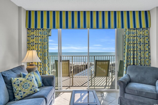 5806 N Ocean Blvd Unit 203, North Myrtle Beach, SC 29582 - tiled living area featuring a water view and wallpapered walls