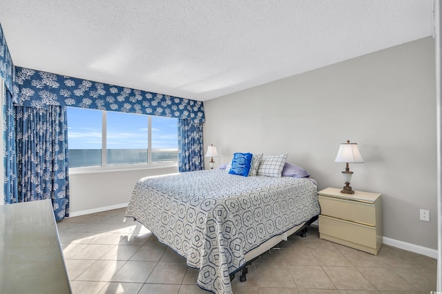 5806 N Ocean Blvd Unit 203, North Myrtle Beach, SC 29582 - tiled bedroom with baseboards and a textured ceiling