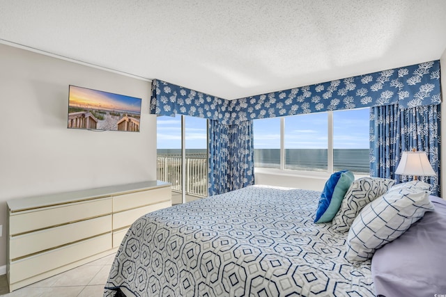 5806 N Ocean Blvd Unit 203, North Myrtle Beach, SC 29582 - tiled bedroom with a water view, access to exterior, and a textured ceiling