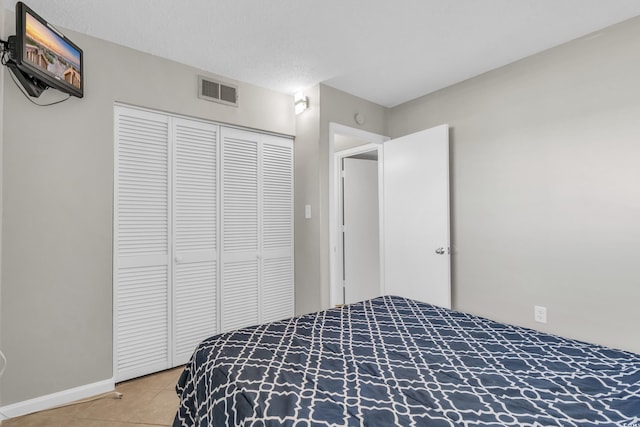 5806 N Ocean Blvd Unit 203, North Myrtle Beach, SC 29582 - bedroom featuring light tile patterned flooring, baseboards, and a closet