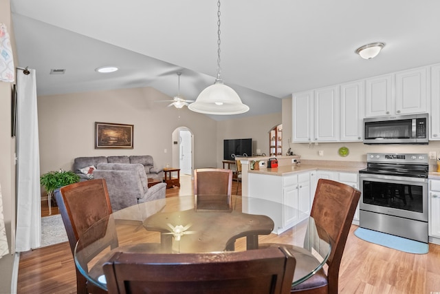 6478 Royal Pine Dr, Myrtle Beach, SC 29588 - dining area with arched walkways, light wood-type flooring, lofted ceiling, and ceiling fan
