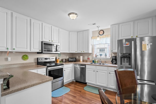 6478 Royal Pine Dr, Myrtle Beach, SC 29588 - kitchen with stainless steel appliances, a sink, white cabinets, and light countertops