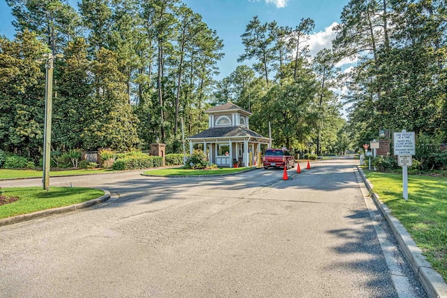 6478 Royal Pine Dr, Myrtle Beach, SC 29588 - view of asphalt road with curbs, traffic signs, and view of scattered trees