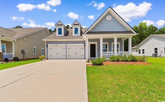 739 Harrison Mill St, Myrtle Beach, SC 29579 - view of front of house featuring covered porch, a garage, driveway, cooling unit, and a front yard