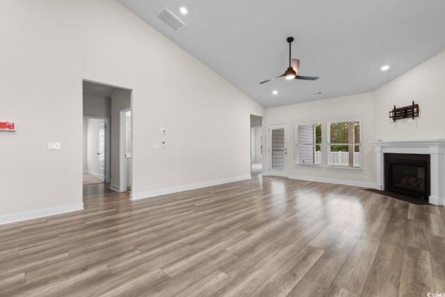 739 Harrison Mill St, Myrtle Beach, SC 29579 - unfurnished living room featuring a ceiling fan, high vaulted ceiling, light wood-type flooring, a fireplace with flush hearth, and baseboards