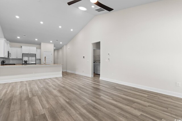 739 Harrison Mill St, Myrtle Beach, SC 29579 - unfurnished living room with ceiling fan, light wood finished floors, high vaulted ceiling, baseboards, and recessed lighting