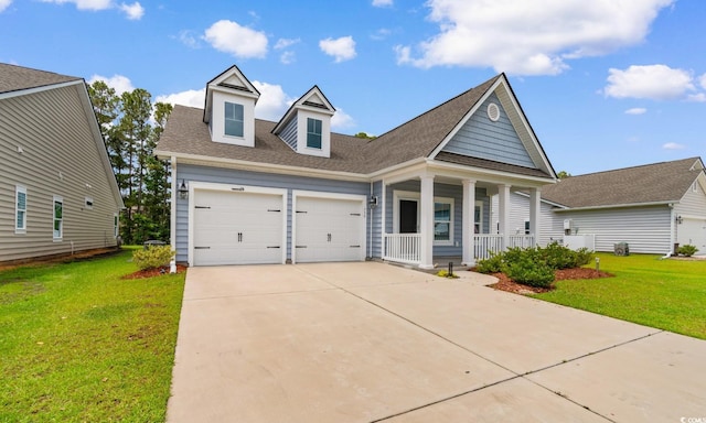 739 Harrison Mill St, Myrtle Beach, SC 29579 - view of front of property with covered porch, a front lawn, concrete driveway, and an attached garage