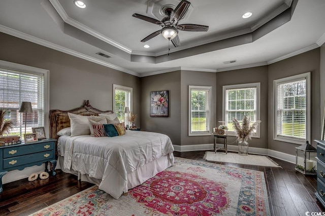 bedroom with a raised ceiling, dark wood-style flooring, ornamental molding, baseboards, and recessed lighting