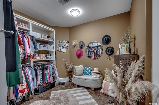 spacious closet with tile patterned floors