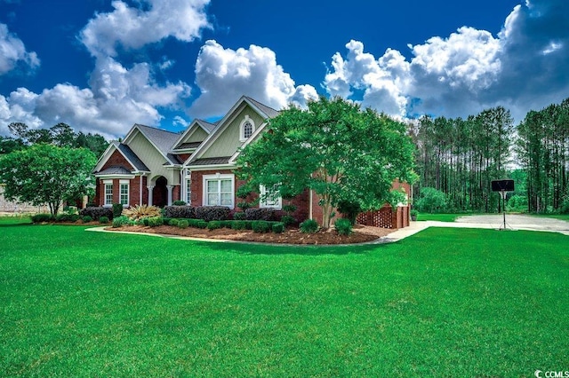 craftsman-style house featuring brick siding, a front lawn, and board and batten siding