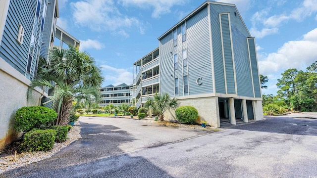 view of property featuring asphalt driveway