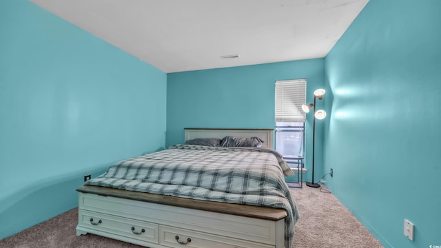 bedroom with carpet flooring and baseboards
