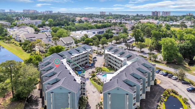 view of urban area with a pool area and a large body of water