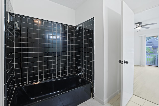 full bath with a ceiling fan, shower / bath combination, tile patterned floors, and baseboards