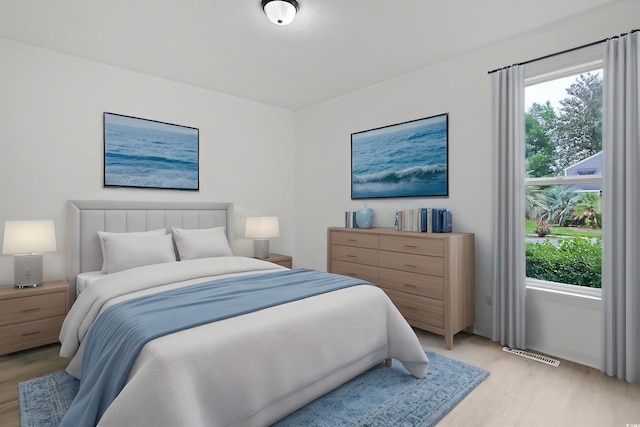 bedroom with light wood finished floors and multiple windows