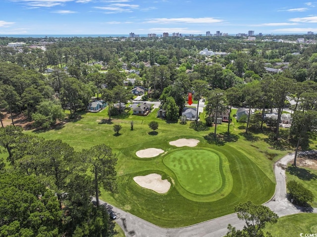 drone / aerial view of a skyline view, a tree filled landscape, and a golf club
