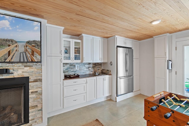 107 Waterway Crossing Ct, Little River, SC 29566 - kitchen featuring freestanding refrigerator, wooden ceiling, concrete floors, white cabinetry, and glass insert cabinets