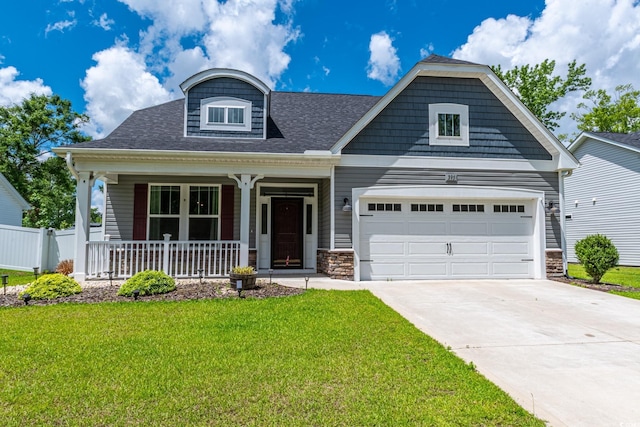 395 Dunbarton Ln, Conway, SC 29526 - craftsman-style house with a porch, a front lawn, concrete driveway, a garage, and stone siding