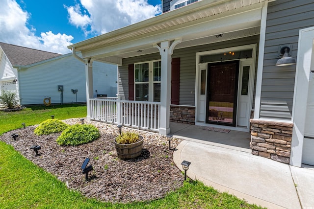 395 Dunbarton Ln, Conway, SC 29526 - doorway to property featuring covered porch, stone siding, and a lawn