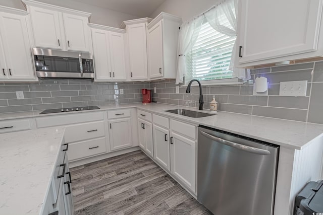 395 Dunbarton Ln, Conway, SC 29526 - kitchen featuring appliances with stainless steel finishes, a sink, white cabinetry, tasteful backsplash, and light stone countertops