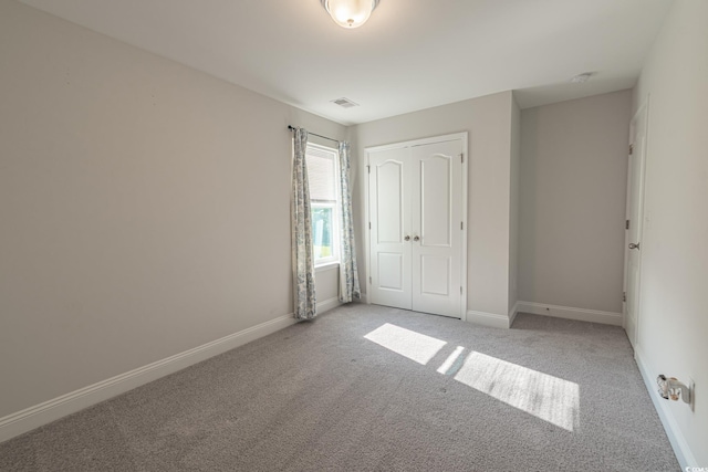 395 Dunbarton Ln, Conway, SC 29526 - unfurnished bedroom featuring light carpet, baseboards, and a closet