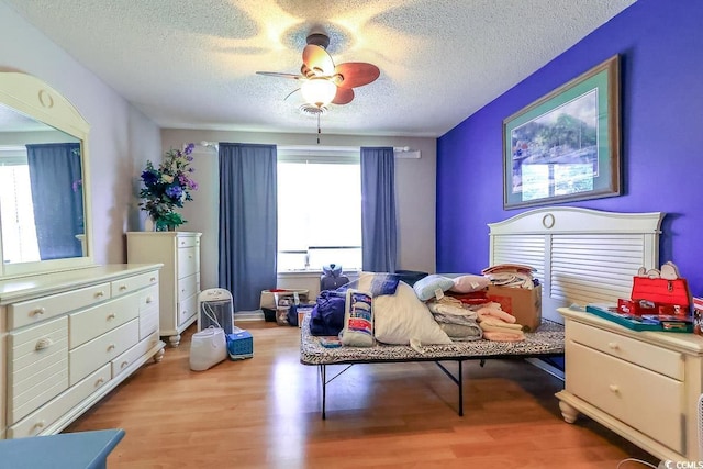 9664 Middleton Ct, Murrells Inlet, SC 29576 - bedroom featuring multiple windows, wood finished floors, a textured ceiling, and ceiling fan