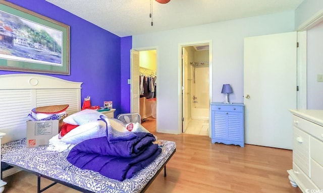 9664 Middleton Ct, Murrells Inlet, SC 29576 - bedroom with light wood finished floors, a spacious closet, connected bathroom, and a closet
