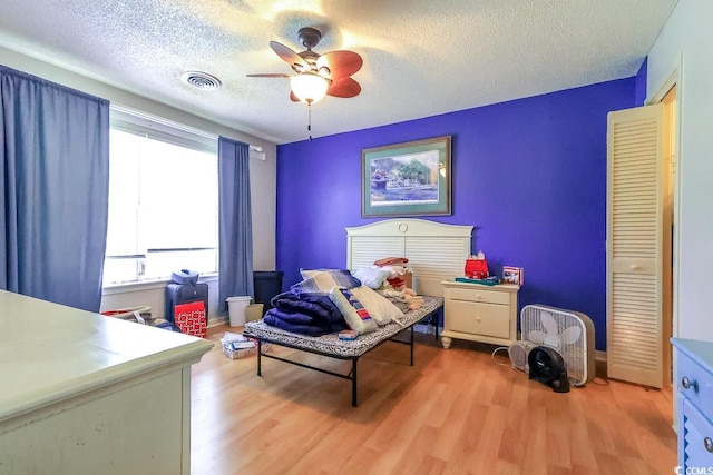 9664 Middleton Ct, Murrells Inlet, SC 29576 - bedroom featuring wood finished floors, a textured ceiling, and ceiling fan
