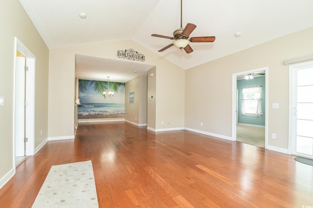 111 Rose Water Loop, Myrtle Beach, SC 29588 - unfurnished living room featuring a ceiling fan, wood-type flooring, lofted ceiling, and a chandelier