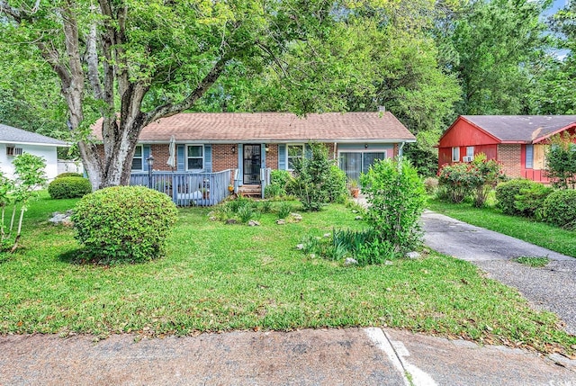 single story home featuring a front lawn and brick siding