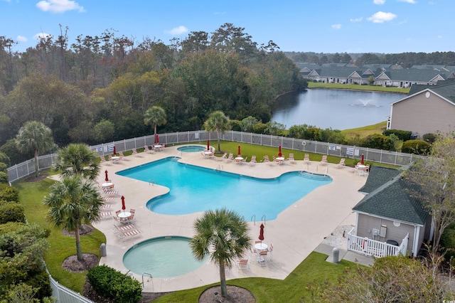community pool with a community hot tub, a patio area, and a water view