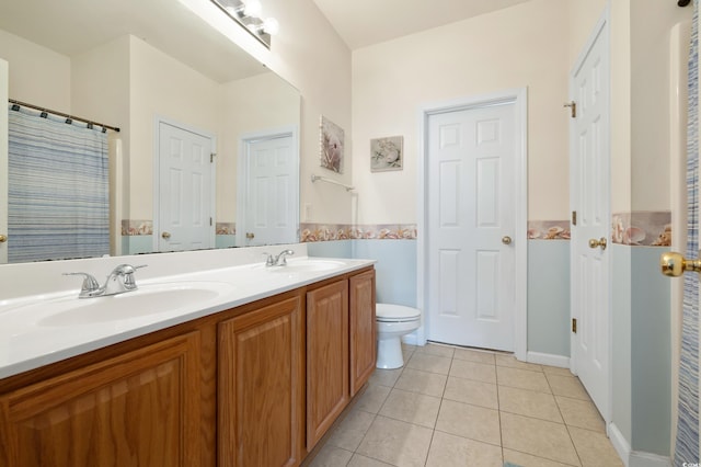 full bathroom featuring tile patterned floors, toilet, and double vanity