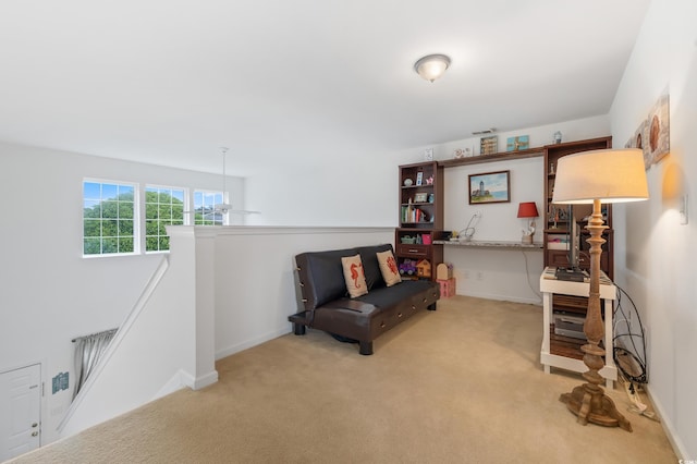living area with an upstairs landing, carpet flooring, and baseboards