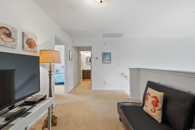living room featuring light carpet and baseboards